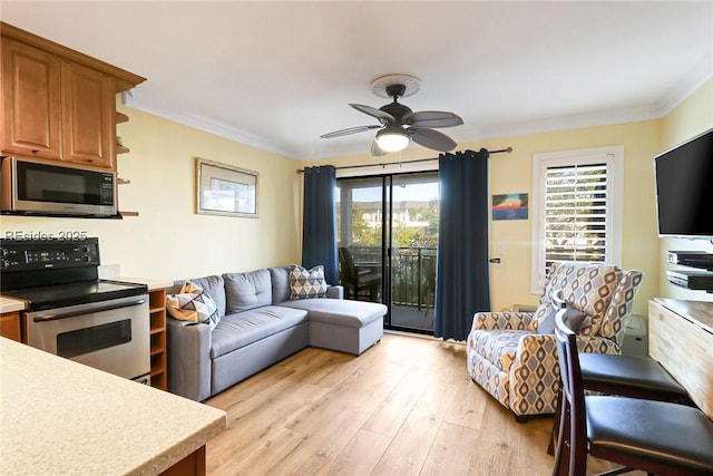 living room with crown molding, ceiling fan, and light wood-type flooring