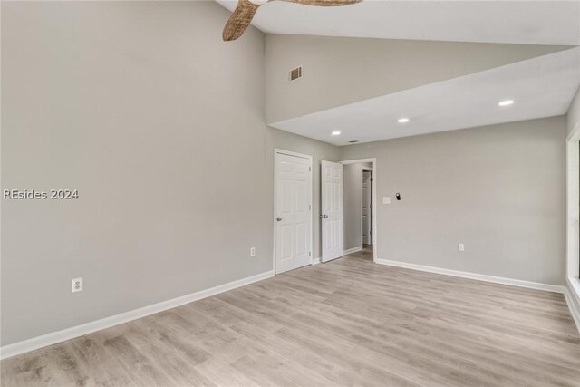 unfurnished room with light hardwood / wood-style flooring and high vaulted ceiling