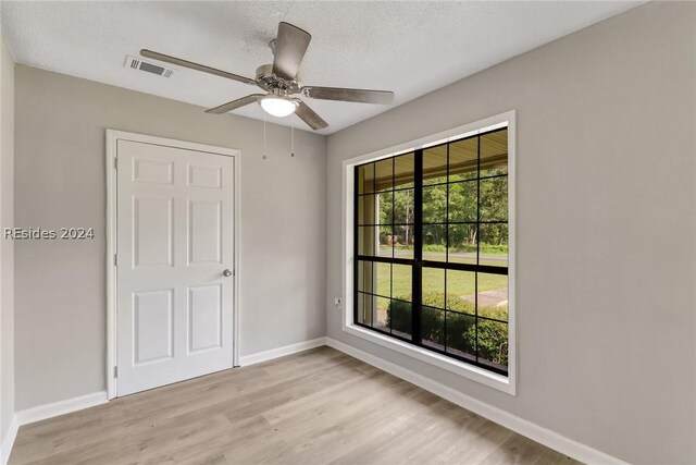 spare room with ceiling fan and light hardwood / wood-style flooring