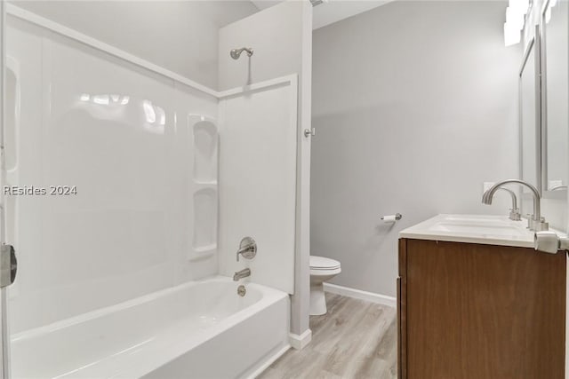 full bathroom with vanity, wood-type flooring, toilet, and washtub / shower combination