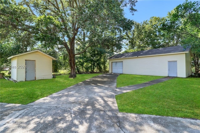 exterior space with a garage, a shed, and a front yard