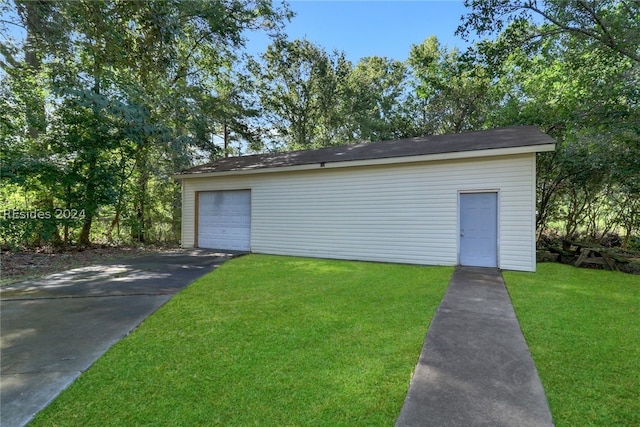 garage featuring a lawn