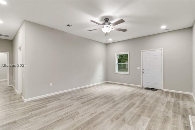 spare room with light hardwood / wood-style flooring and ceiling fan