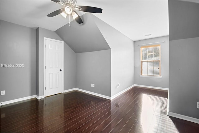 bonus room with ceiling fan, dark hardwood / wood-style flooring, and vaulted ceiling