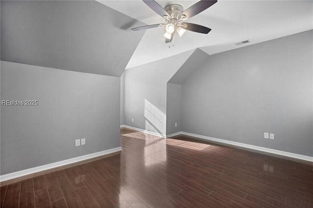 additional living space featuring vaulted ceiling, dark hardwood / wood-style floors, and ceiling fan