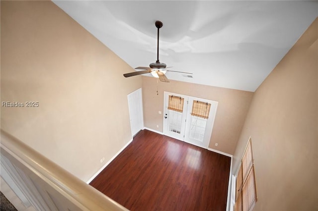 unfurnished living room featuring ceiling fan, lofted ceiling, and dark hardwood / wood-style flooring