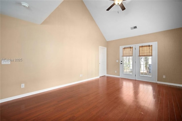 empty room featuring high vaulted ceiling, dark wood-type flooring, and ceiling fan