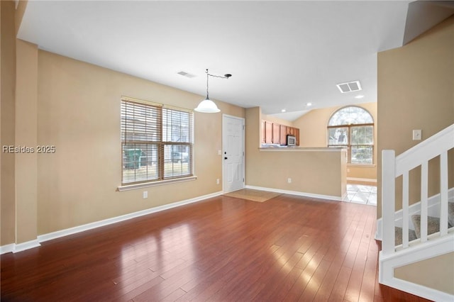 unfurnished living room featuring hardwood / wood-style flooring