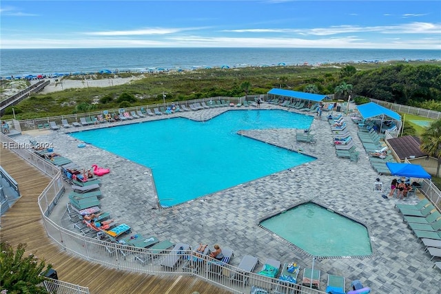 view of swimming pool featuring a water view