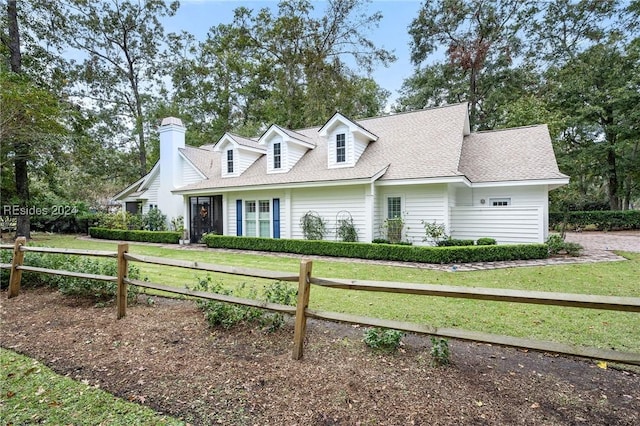 new england style home featuring a front yard