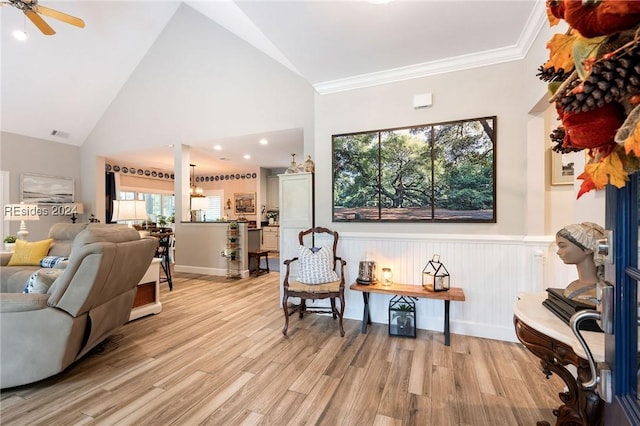 living room with high vaulted ceiling, light hardwood / wood-style flooring, ornamental molding, and ceiling fan