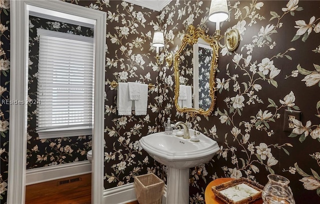 bathroom with hardwood / wood-style floors and toilet