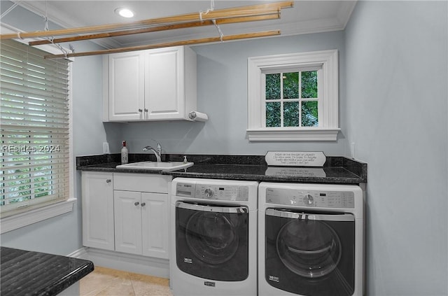 clothes washing area featuring separate washer and dryer, sink, a healthy amount of sunlight, and light tile patterned flooring