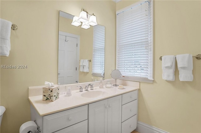 bathroom featuring vanity and toilet