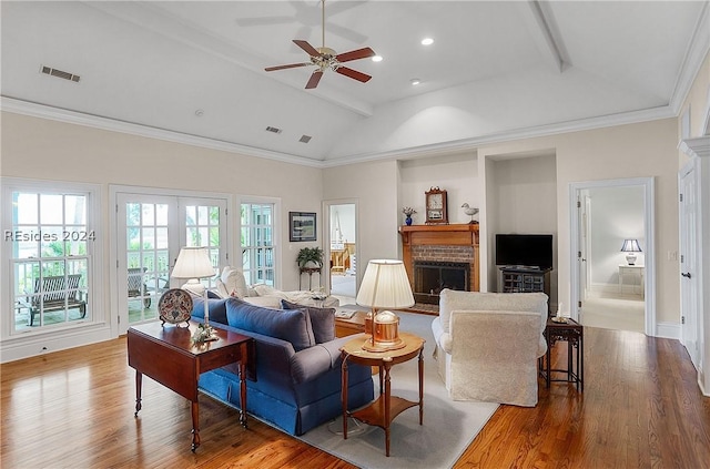 living room featuring crown molding, beam ceiling, and a fireplace