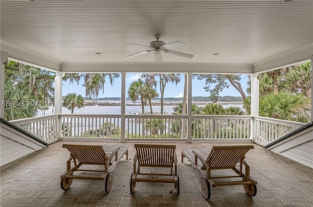 view of patio with a water view and ceiling fan