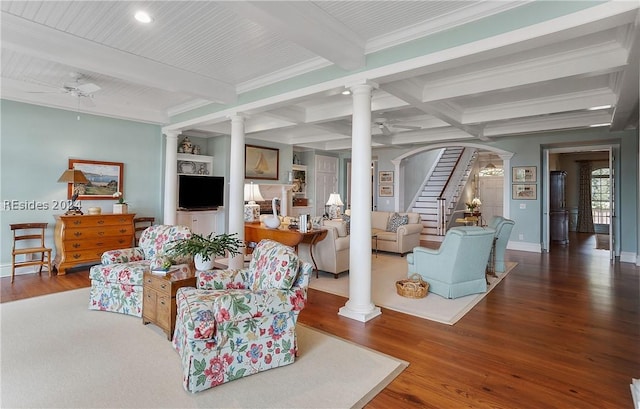 living room featuring ceiling fan, beam ceiling, hardwood / wood-style floors, and ornate columns