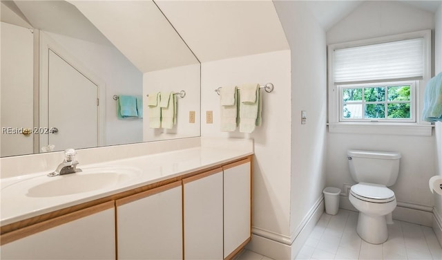 bathroom featuring lofted ceiling, vanity, and toilet