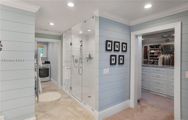 bathroom featuring washer / clothes dryer, ornamental molding, and walk in shower