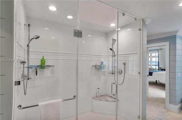 bathroom with a shower with door