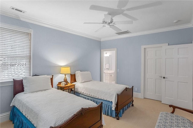 carpeted bedroom featuring crown molding, ensuite bathroom, and ceiling fan