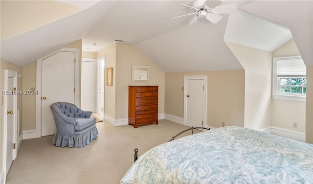 bedroom with vaulted ceiling, light carpet, and ceiling fan