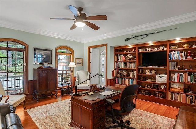 office space featuring crown molding, ceiling fan, and light wood-type flooring