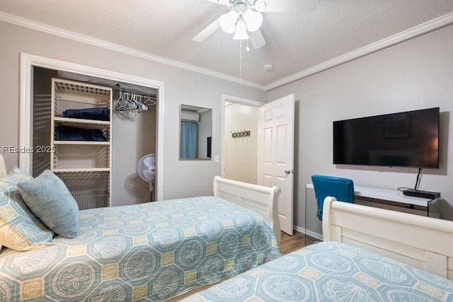 bedroom featuring crown molding, a textured ceiling, a closet, hardwood / wood-style flooring, and ceiling fan