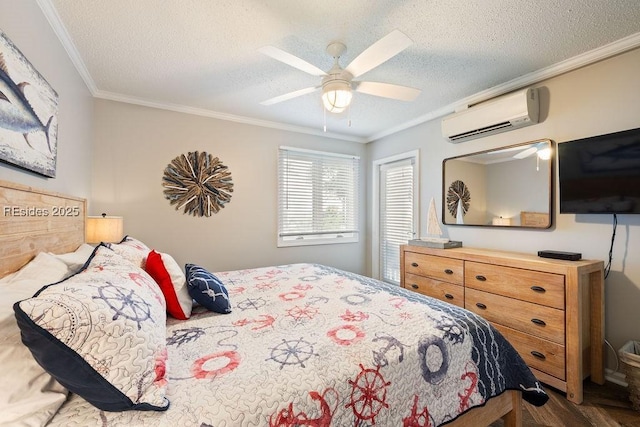 bedroom with ceiling fan, crown molding, a textured ceiling, and a wall unit AC