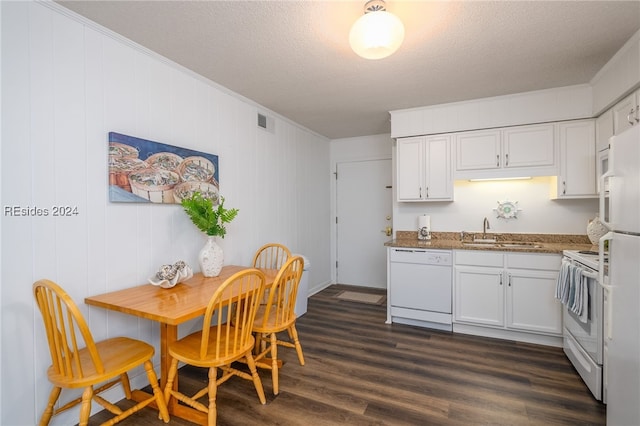 kitchen featuring sink, a textured ceiling, white cabinets, and white appliances