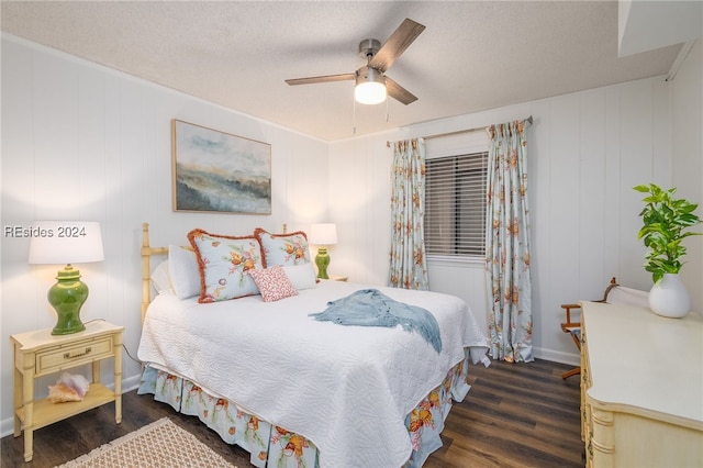 bedroom featuring dark hardwood / wood-style flooring, a textured ceiling, and ceiling fan