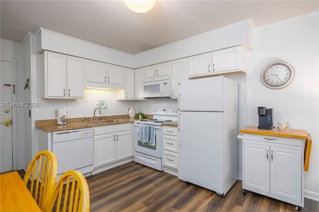 kitchen with sink, white appliances, white cabinetry, dark hardwood / wood-style floors, and a textured ceiling