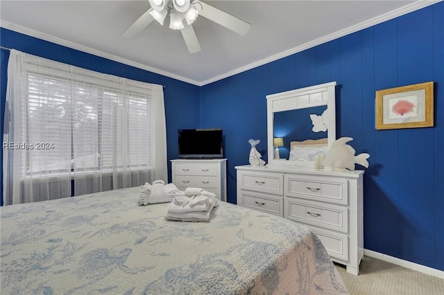 carpeted bedroom with ornamental molding and ceiling fan