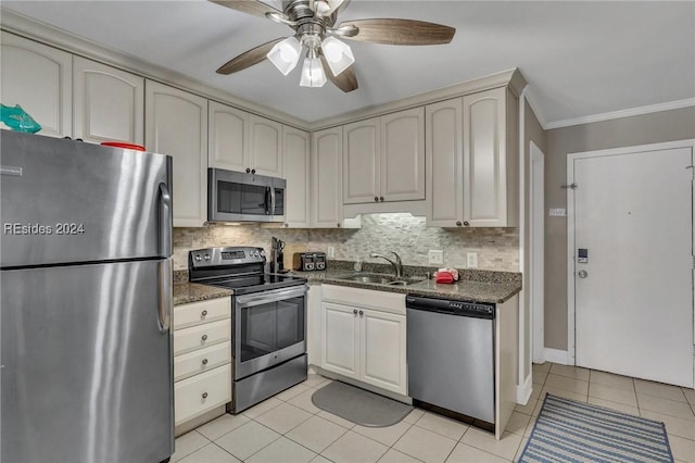 kitchen featuring crown molding, appliances with stainless steel finishes, sink, and light tile patterned floors