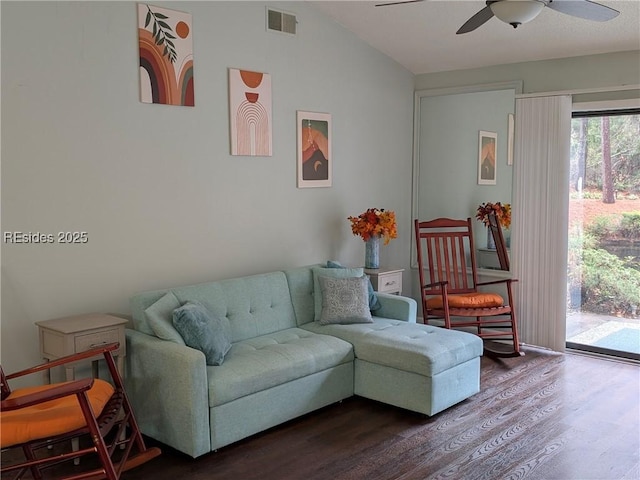 living room featuring hardwood / wood-style floors, vaulted ceiling, and ceiling fan