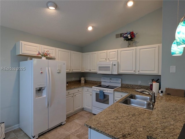 kitchen with sink, white appliances, white cabinets, vaulted ceiling, and kitchen peninsula