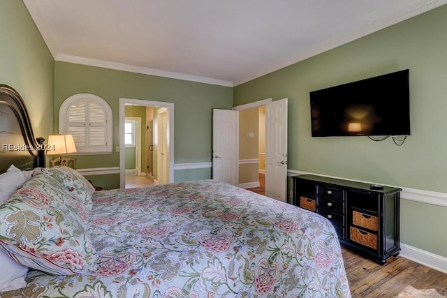 bedroom with ornamental molding and wood-type flooring