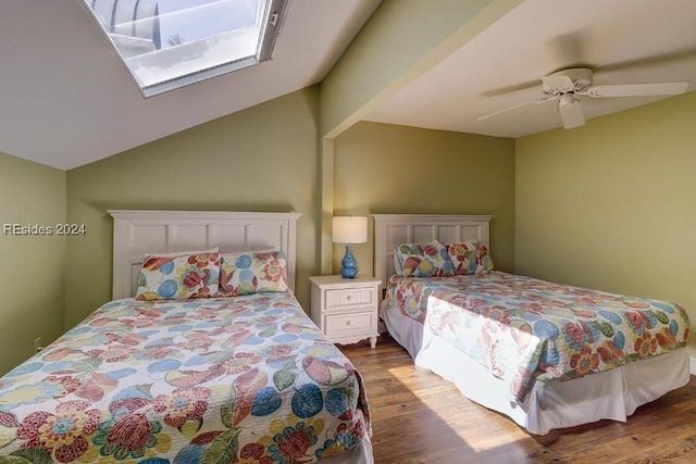 bedroom with ceiling fan, lofted ceiling, and hardwood / wood-style floors