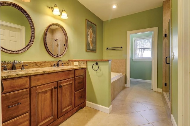 bathroom featuring independent shower and bath, vanity, and tile patterned floors