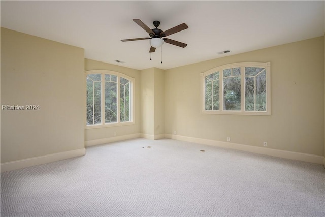 spare room with carpet floors and ceiling fan