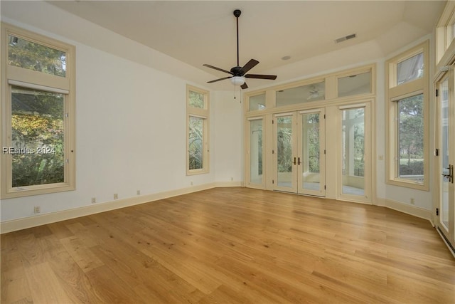 interior space with french doors, ceiling fan, and light wood-type flooring