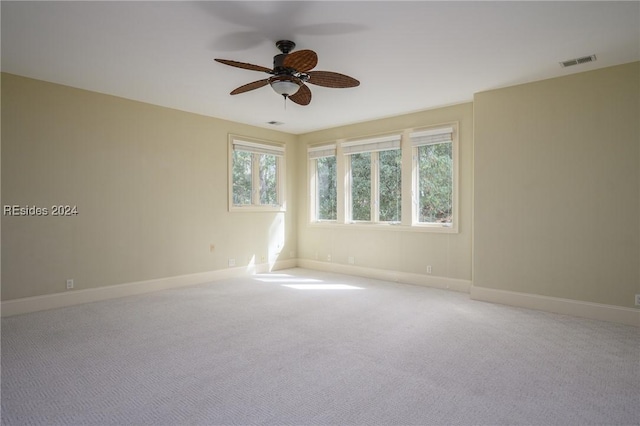 carpeted empty room featuring ceiling fan