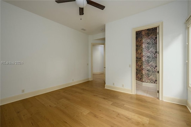 unfurnished bedroom featuring light hardwood / wood-style flooring, ceiling fan, and ensuite bathroom