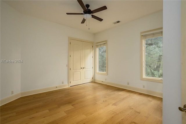 unfurnished room with ceiling fan and light wood-type flooring