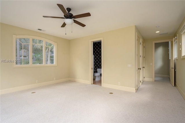 empty room with light colored carpet and ceiling fan