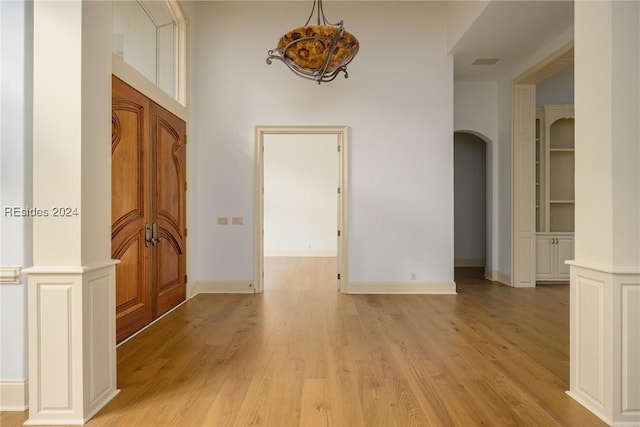 interior space featuring light wood-type flooring and built in shelves