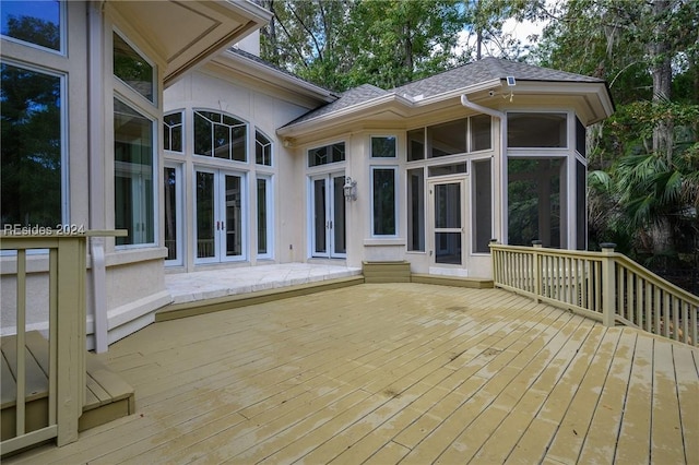 deck with a sunroom and french doors