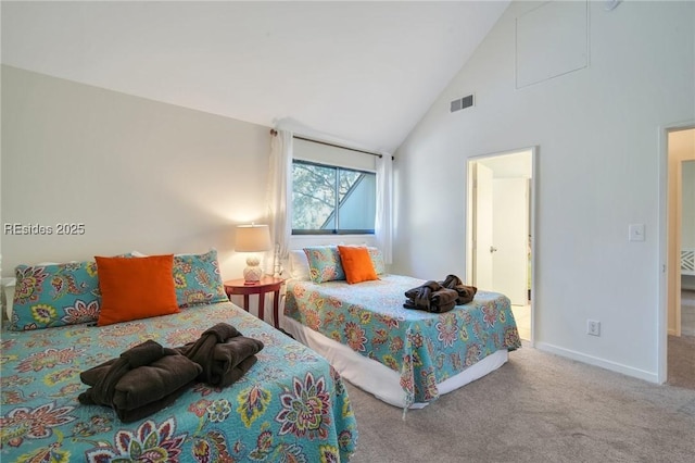 bedroom with carpet floors and high vaulted ceiling