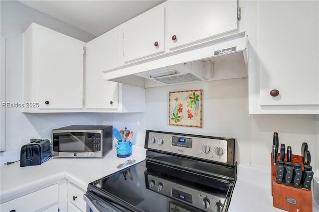 kitchen featuring white cabinets and appliances with stainless steel finishes