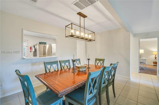 dining area with light tile patterned floors and a notable chandelier